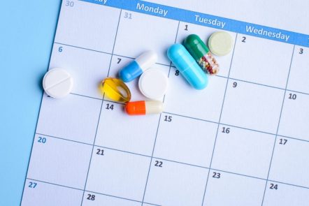 Pills on a calendar daily and weekly schedule